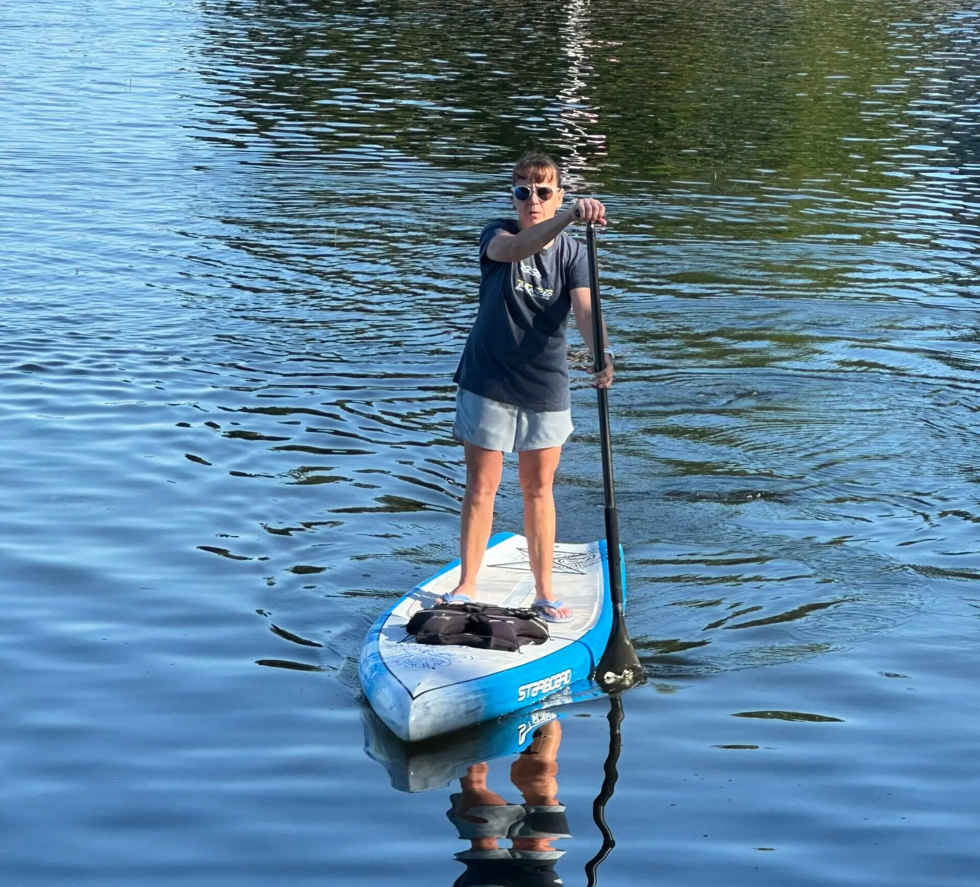 woman paddle boarding on water